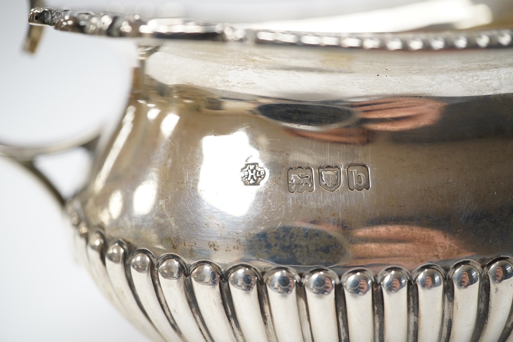 A late Victorian demi-fluted silver sugar bowl and a matching milk jug, by William Hutton & Sons, London, 1897, 12.6oz. Condition - good